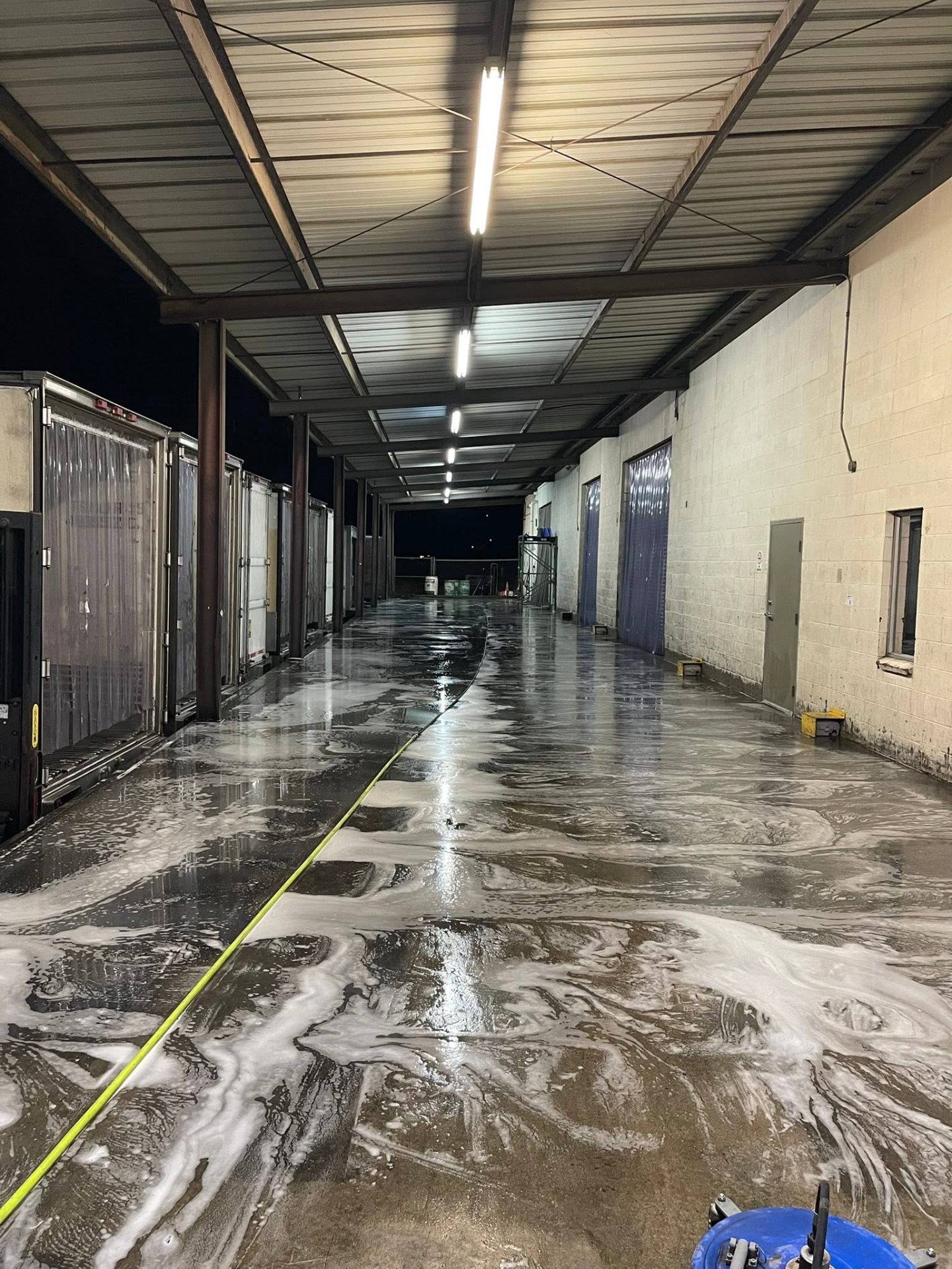 Warehouse dock floor being pressure washed